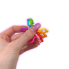 Dinky Things Fidgets - Starry Swirl is a rainbow of colourful starry beads that make a sweet tinkling sound as you fidget.
