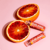 The Crazy Rumours Blood Orange Lip Balm is more than just a lip care product; it’s a small, delightful escape to a sun-kissed citrus grove.