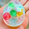 Handmade Sensory Stones - Sparkle Sea Worry Stone by Sensory Oasis for Kids. Smooth resin sensory stones with raised ocean-inspired details for tactile sensory input and pocket-sized calm.