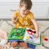 The Fabric Activity Book - Away We Go is a Montessori inspired quiet book featuring travel, camping and transport activities that build fine motor skills, imagination and independent learning.