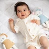 Meet Molly the Mouse, a soft 100% cotton knitted toy with a pale blue dress, matching bow and embroidered details. Perfect for cuddles, comfort and sensory play.