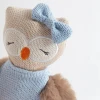 Meet Ollie the Owl, a soft 100% cotton knitted toy with fluffy wings, embroidered features and a cosy blue dress. Perfect for cuddles and sensory play.