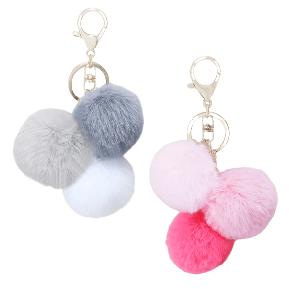 This charming Pom Poms Keychain Pink features a trio of pom poms in varying shades of pink or grey, adding a burst of colour and fun to your keys or bag.