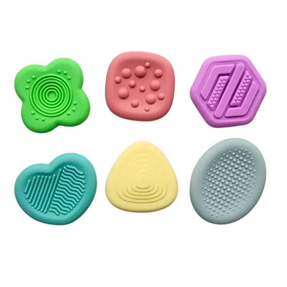 The Sensory Stone Fidgets Pastel set includes six stone-shaped silicone fidgets, each with a unique texture to engage your tactile senses, improve focus, and help with stress relief.
