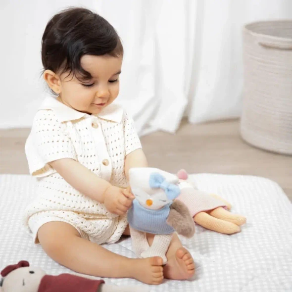 Meet Ollie the Owl, a soft 100% cotton knitted toy with fluffy wings, embroidered features and a cosy blue dress. Perfect for cuddles and sensory play.