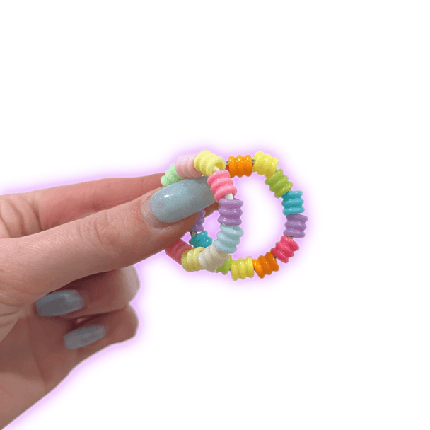Dinky Things Fidgets - Rolly Ring is a mini fidget with cute little rainbow textured beads that are super satisfying to twist and twirl.