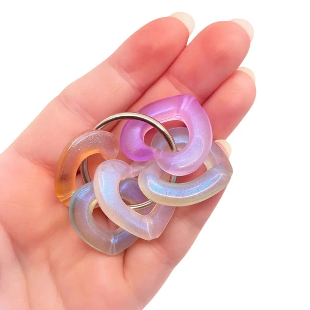 Dinky Things Fidgets - Tinkle Hearts is a gorgeous fidget with smooth pearlescent heart shaped beads that make a great sound for fun sensory input.