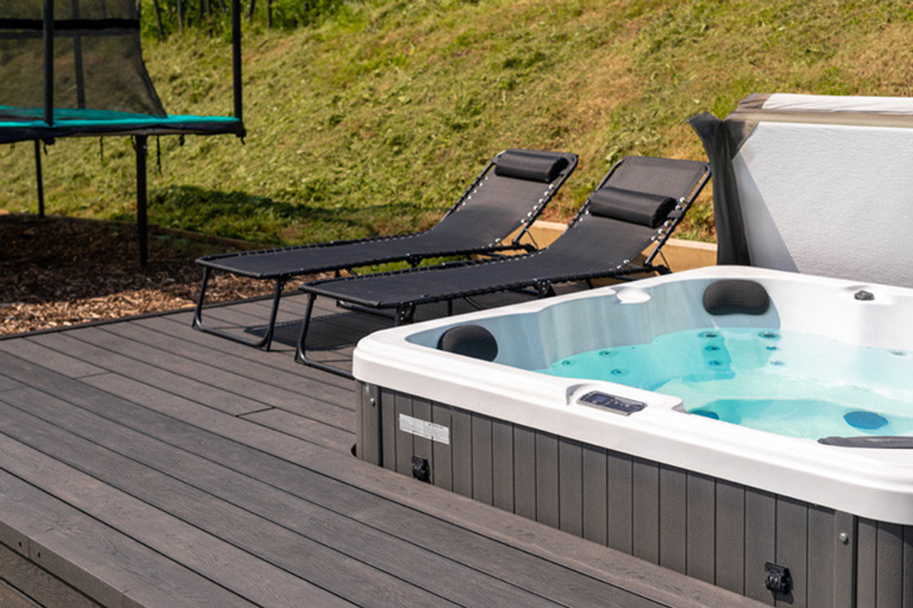 Cladco Reversible Solid Composite Decking Stone Grey in situ hot tub