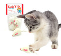 gray and white kitten batting a white real rabbit fur mouse cat toy with a package of real rabbit fur white mice in the background