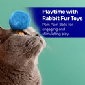 gray cat with blue real rabbit fur pom toy on its head listing stimulating play