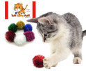 white and gray kitten batting a tuff kitty puff standard size red sparkle pom cat toy