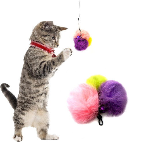 gray striped kitten on its hind legs playing with a 3 pom real rabbit fur handmade teaser with bell, pink, yellow, purple