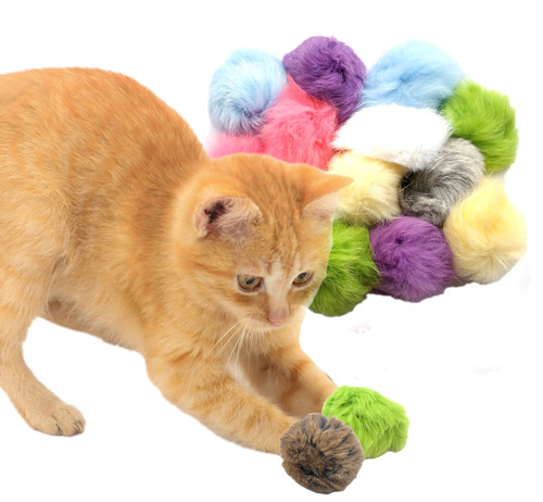 orange kitten playing with pink real rabbit fur pom cat toy with package in the background