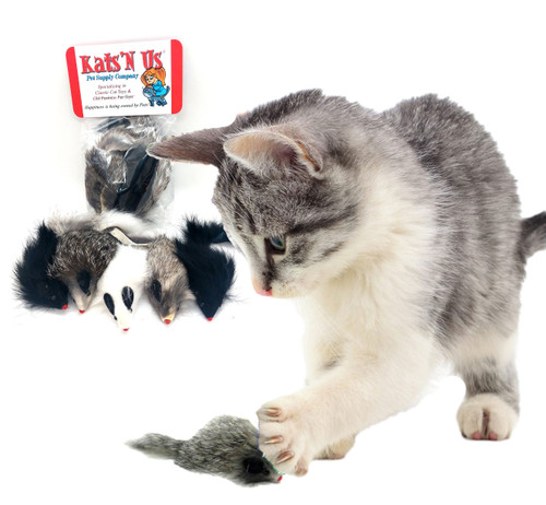 white and gray tabby kitten batting around a real rabbit fur gray long hair mouse toy with a package of real rabbit fur mice in the background