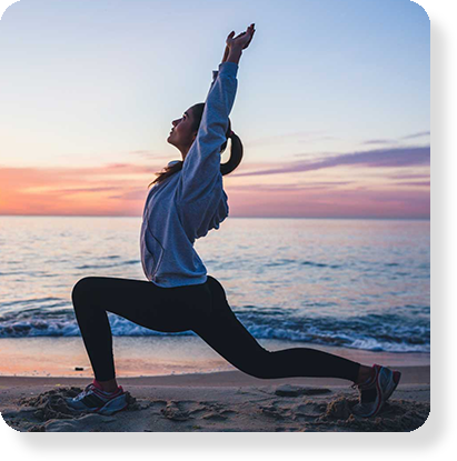 Young woman stretching on the beach