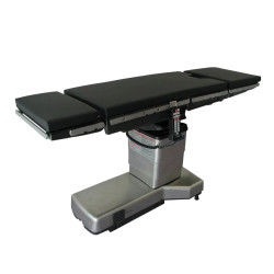 Amsco 3085 SP Surgical Table with black cushions, stainless steel base, and attached hand control.