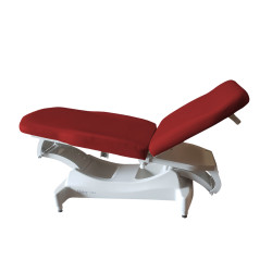 Ritter 244 power treatment table with red upholstery in a reclined position, featuring a white base and adjustable segments.