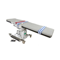 Morgan MEDesign C-arm table with gray cushion and safety straps.