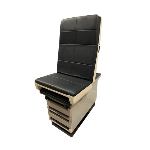 Midmark Ritter 404 exam table with black upholstered backrest and seat, featuring multiple drawers and pull-out footrest.