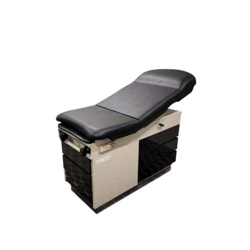 Midmark 104 exam table with black round-top upholstery and built-in stirrups.