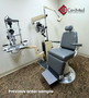 Reliance 880 exam chair refurbished with foot control, cruiser gray upholstery, next to a medical equipment in a medical room.