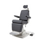 Reliance 6200H ENT exam chair displayed at an angle, shown in a semi-reclined position with dark gray upholstery, adjustable headrest, padded armrests, integrated side control panel, and footrest; connected to an external foot pedal control on the floor.