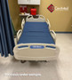 Refurbished Hill-Rom VersaCare in a clinic room with a blue mattress.