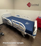 Refurbished Stryker S3 3002 in a clinic room with a blue mattress.