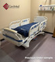 Refurbished Stryker S3 3002 in a clinic room with a blue mattress.