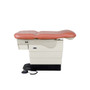 Midmark Ritter 623 exam table with terra cotta upholstery, and foot control shown in side view.
