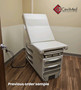 Midmark Ritter 204 manual examination table with white upholstery and drawers.
