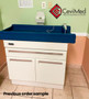Midmark 640 pediatric exam table with a bright blue upholstered top and cream base, installed in a tiled exam room with light green and peach walls.