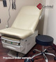 Midmark Ritter 223 refurbished with pearl upholstery and a black matching stool in a medical room.