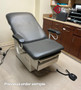 Midmark Ritter 223 refurbished with gray upholstery and armrests in a medical room.