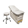 Midmark 604 manual examination table with light gray cushions and matching rolling stool, featuring gray-accented drawers and a yellow step.