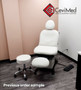 White Midmark 630 procedure chair refurbished with headrest and footrest in a corner room with dark flooring.