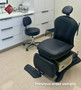 Midmark 641 refurbished with black upholstery, a matching stool, and a foot control in a medical room.