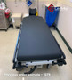 Refurbished Stryker 1069 in a clinic room with a black mattress.