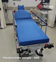 Refurbished Stryker 1069 in a clinic room with a blue mattress.