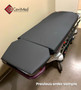 Refurbished Stryker 1061 in a clinic room with a black mattress.