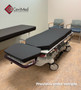 Refurbished Stryker 1061 in a clinic room with a black mattress.