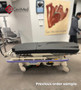 Refurbished Hill-Rom P8050 in a clinical room with a black mattress.