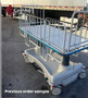 Refurbished Hausted pediatric stretcher in a parking of a clinic.