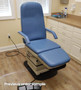 Midmark 417 refurbished in pacific blur upholstery with armrests, placed in a medical exam room.