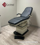 Refurbished Midmark 417 with gblack upholstery, and a foot control in a clinic room.