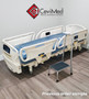 Refurbished Stryker FL28C in a clinic room with a blue mattress.