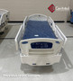 Refurbished Stryker FL28C in a clinic room with a blue mattress.