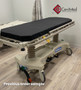Hill-Rom P8000 refurbished in a medical room with black mattress.