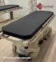 Hill-Rom P8000 refurbished in a medical room with black mattress.