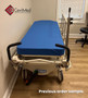 Hill-Rom P8000 refurbished in a medical room with blue mattress.